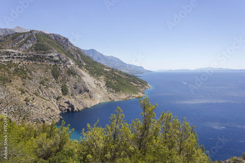 Dalmatian coastline with its cliff and streets through mountains, by the sea