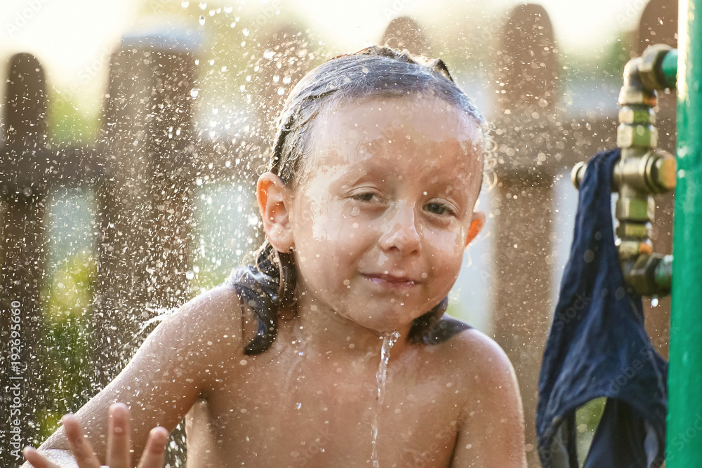 water fun. girl in the shower splashing water. water fun. girl in the shower splashing water.