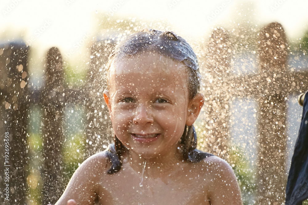 water fun. girl in the shower splashing water. water fun. girl in the shower splashing water.