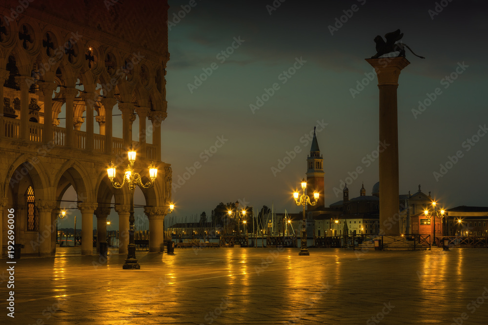Famous Doge palace, column with winged lion and San Marco square at sunrise in Venice, Italy