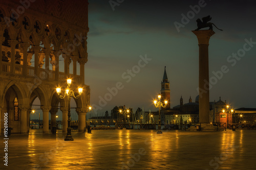 Famous Doge palace, column with winged lion and San Marco square at sunrise in Venice, Italy