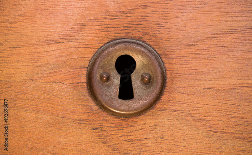Old rusty and dusty keyhole wallpaper. Vintage keyhole on old wooden door background. Keyhole of old door. photo