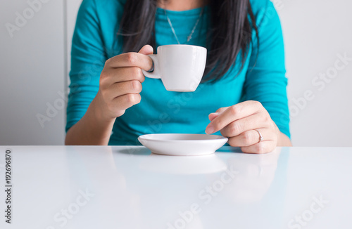 Woman hand holding a cup of coffee,close up