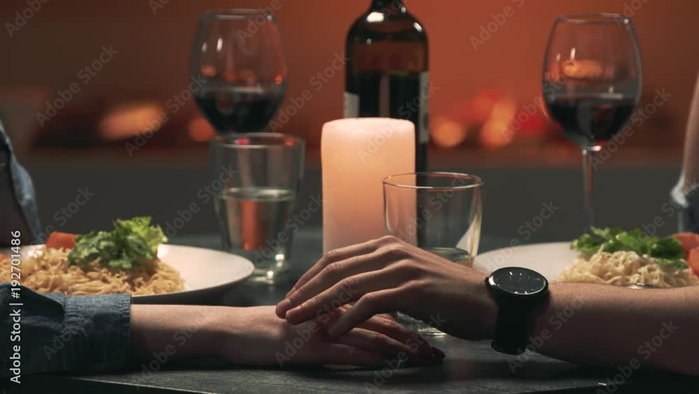 Man touches woman's hand during a romantic date. Close-up Man touches woman's hand during a romantic date. Close-up