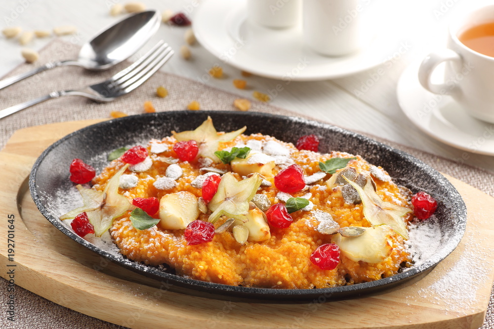 pumpkin porridge on white wooden background