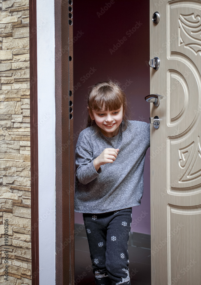 The little girl comes home from the landing and closes the door The little girl comes home from the landing and closes the door