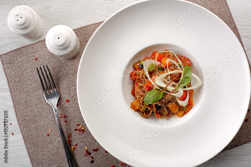 salad of stewed vegetables on a white wooden background