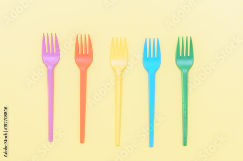 colorful forks on yellow background