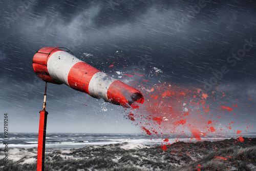 Damaged windsock and stormy sea - storm warning photo