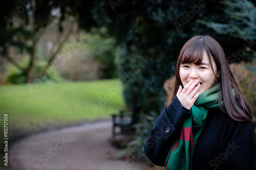 A beautiful young Japanese lady in the park