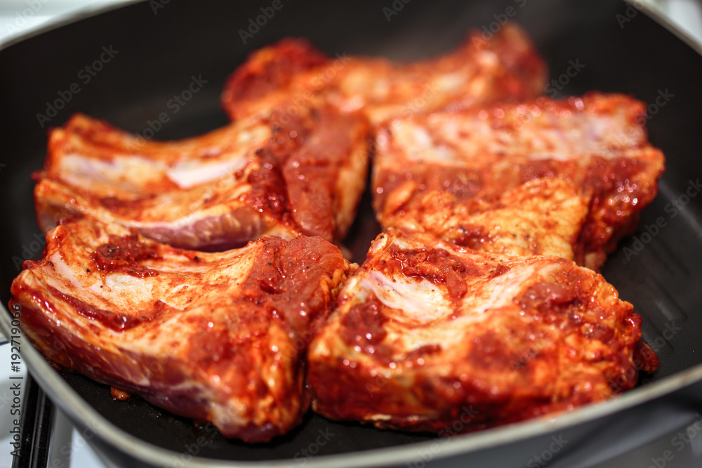 Seasoned pork ribs in the frying pan Seasoned pork ribs in the frying pan