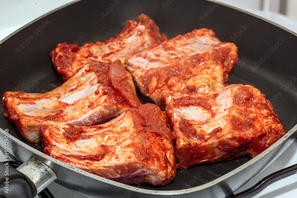 Seasoned pork ribs in the frying pan