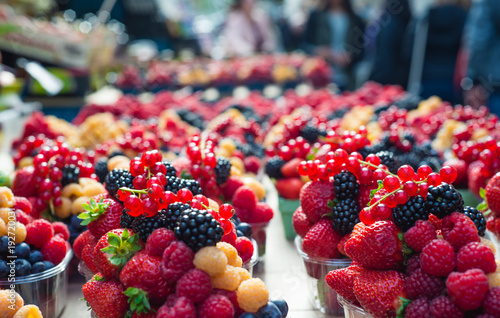 Yellow red raspberries and blackberries at a farmer s market