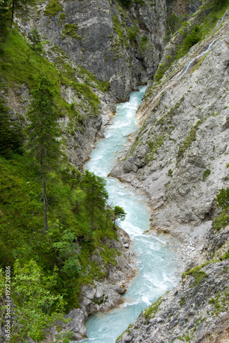 Clear blue mountain stream between steep rocks