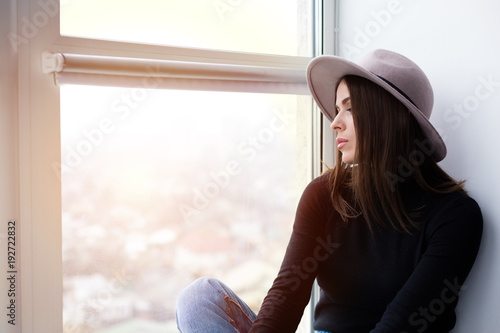 Free Download Beautiful boho woman in wool hat sitting by the window - GFXLoad