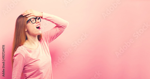 Young woman making a mistake on a solid background photo