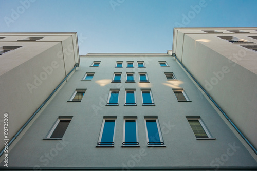 symetric facade of apartment complex in cold colors