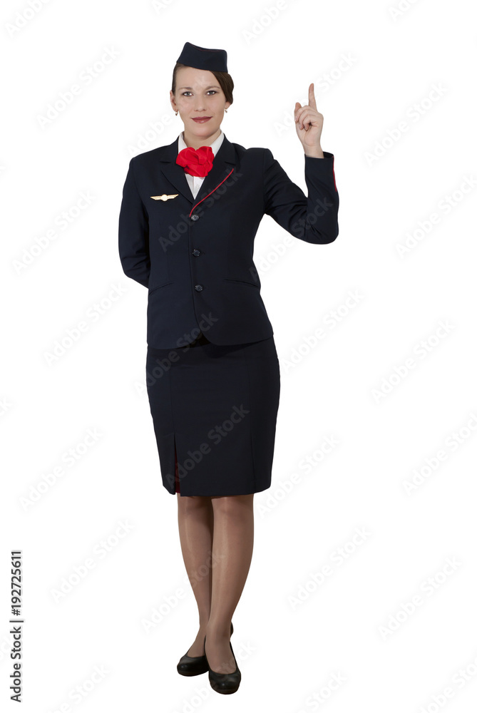 stewardess in full growth on a white background stands and shows the index finger up stewardess in full growth on a white background stands and shows the index finger up