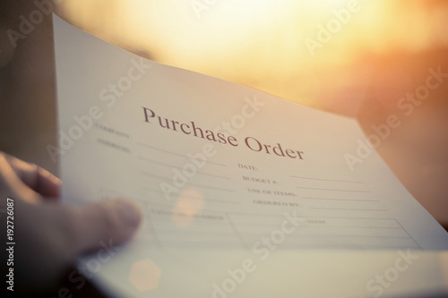 Fill in the purchase items in an order form,Close up of purchase order form with pen / selective focus