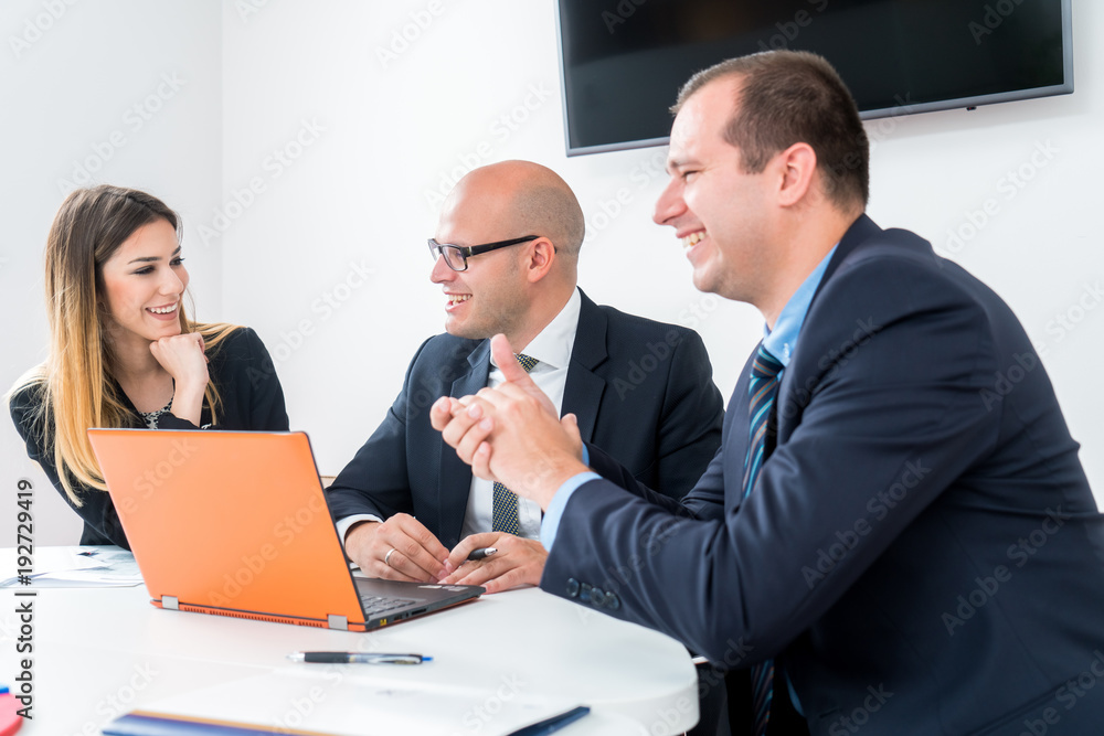 A business team of three sitting in office and planning work. Using laptop to make business strategy. Startup in developement. A business team of three sitting in office and planning work. Using laptop to make business strategy. Startup in developement.