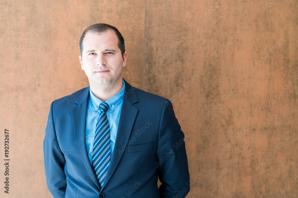 Handsome confident businessman portrait. Portrait of a handsome CEO. Handsome executive business man at the workspace office Handsome confident businessman portrait. Portrait of a handsome CEO. Handsome executive business man at the workspace office