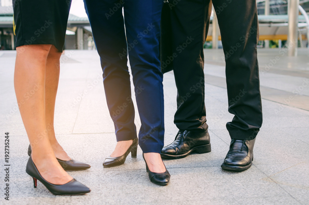 close up legs of group three business people woman and woman team standing at big business district in city together, congratulation, success, meeting, partner, teamwork, community, connection concept close up legs of group three business people woman and woman team standing at big business district in city together, congratulation, success, meeting, partner, teamwork, community, connection concept