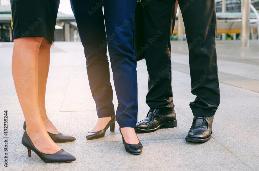 close up legs of group three business people woman and woman team standing at big business district in city together, congratulation, success, meeting, partner, teamwork, community, connection concept