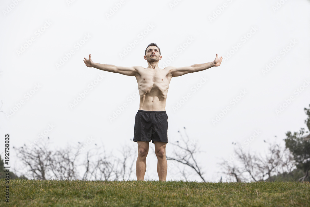 man performing abdominal exercise on the grass man performing abdominal exercise on the grass