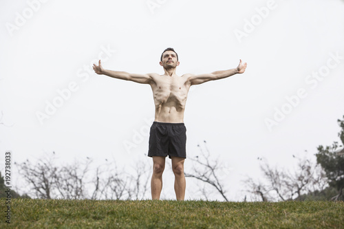 man performing abdominal exercise on the grass