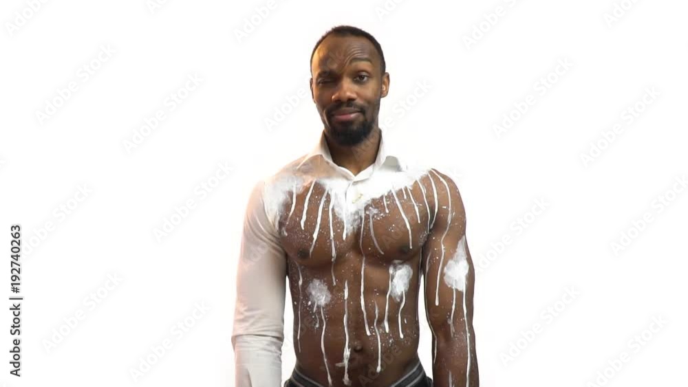 Cute black man in body art gets a gift, a hint of sex, an erotic gift, slow motion Cute black man in body art gets a gift, a hint of sex, an erotic gift, slow motion