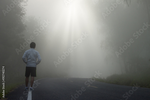 Men walk in the foggy on the street.