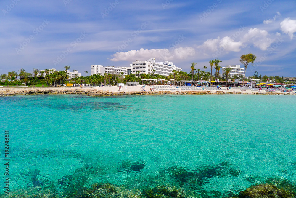 Obraz premium AYIA NAPA, CYPRUS - MAY 9, 2011: View of hotels on beach of Ayia Napa. Cyprus is most visited island on Mediterranean Sea.