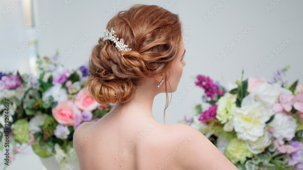 Back view of amazing young bride. Red head woman seat on the chair. Elegant hairstyle. Back view of amazing young bride. Red head woman seat on the chair. Elegant hairstyle.