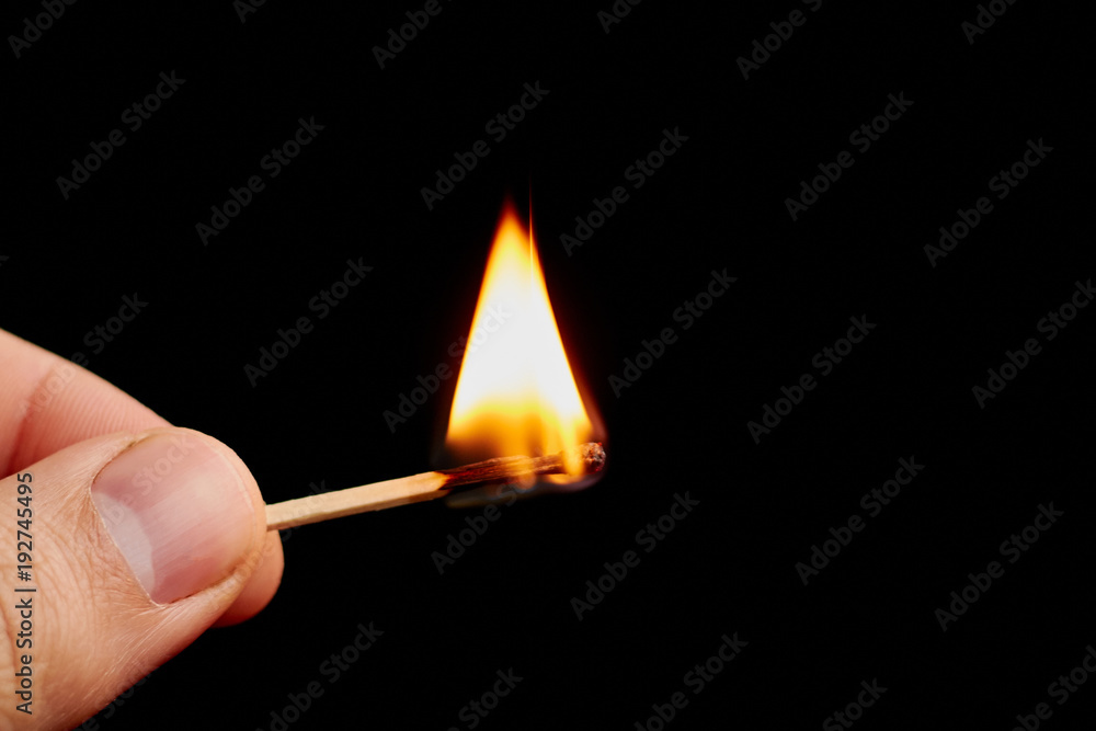 Matchstick in hand isolated on black background Matchstick in hand isolated on black background