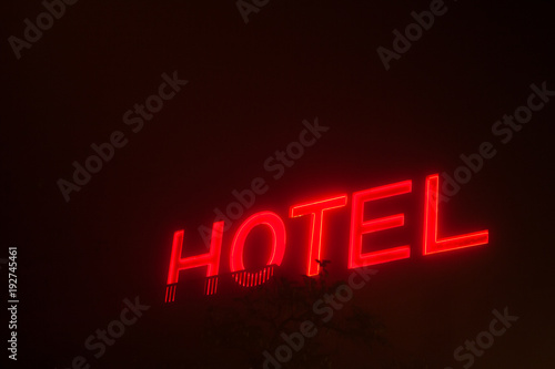 Hotel sign at night with fog