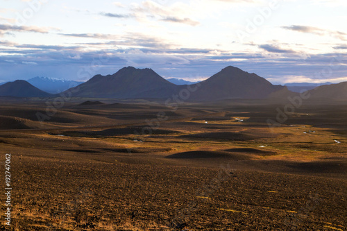 Central Highlands of Iceland, red brown mountain landscape shaped by volcanic activity, inland view of Iceland's wild nature on the warm sunset light