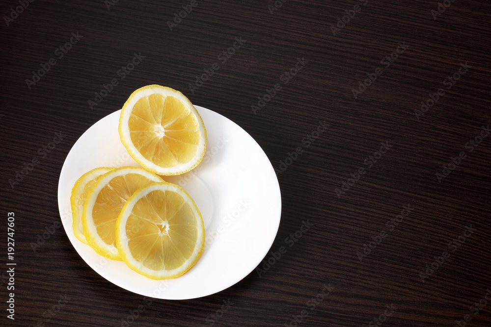 Lemon in a plate on a wooden background Lemon in a plate on a wooden background