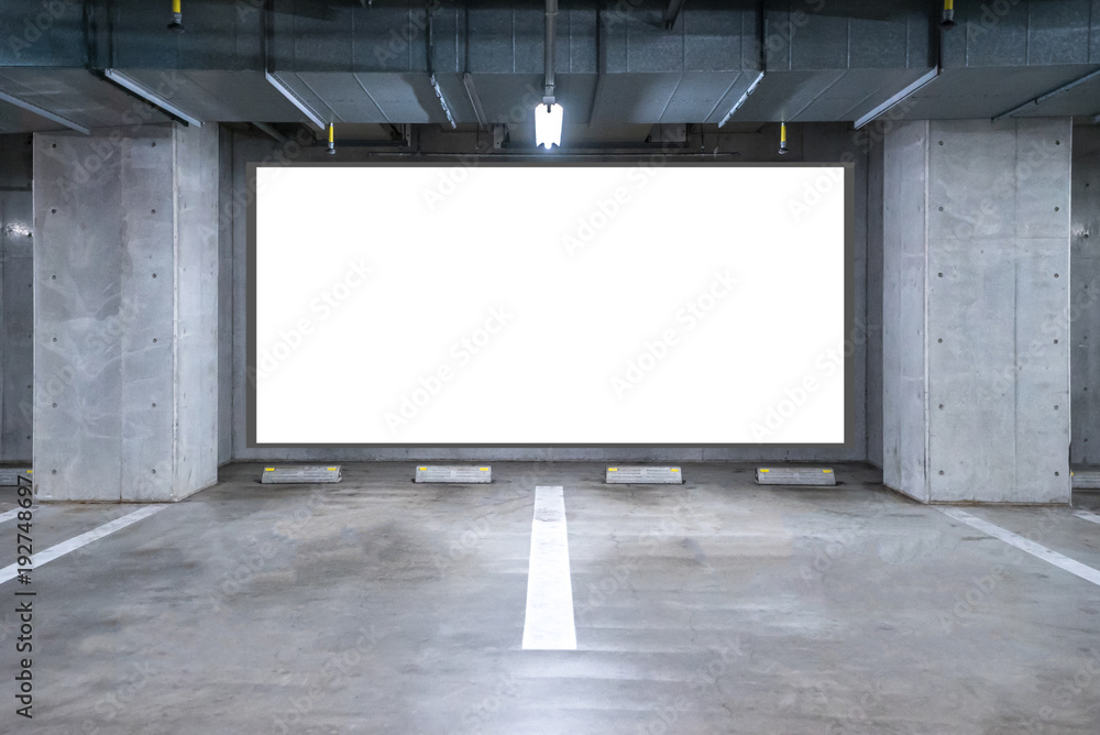 Parking garage underground with blank billboard
