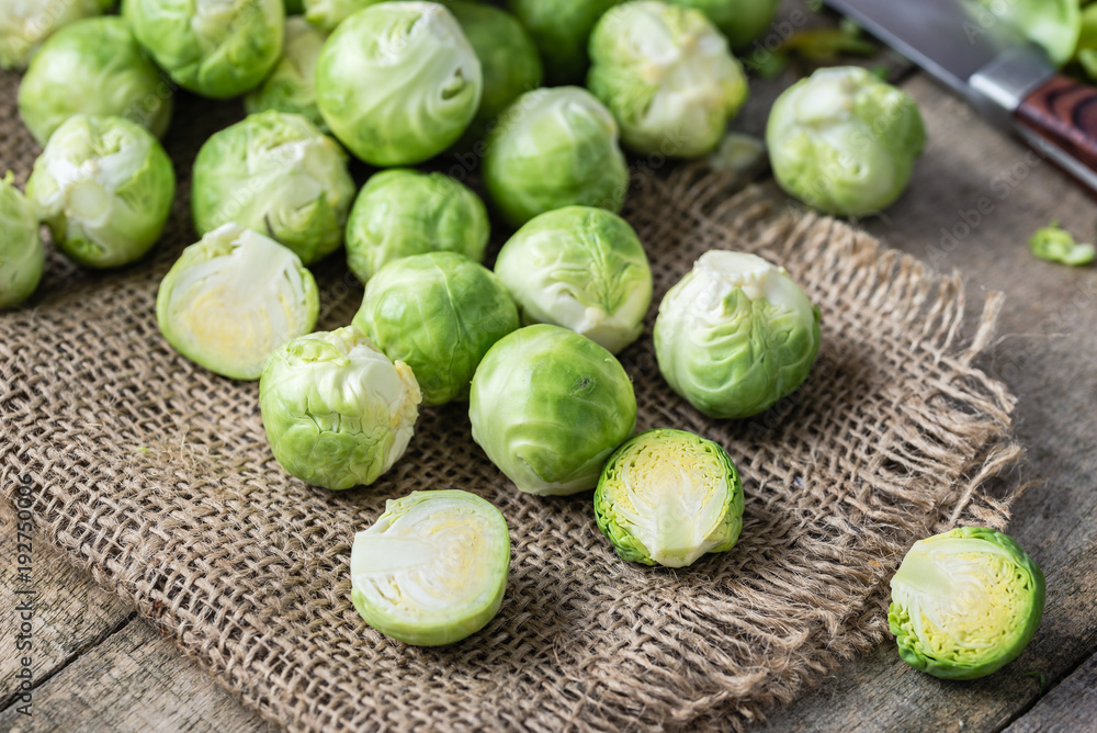Raw brussels sprouts on jute background. Raw brussels sprouts on jute background.
