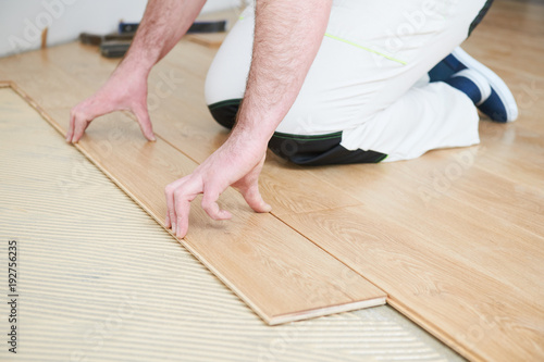 worker joining parquet floor.