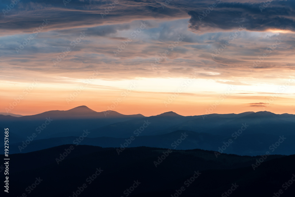 Picturesque summer landscape with colorful sunrise on Carpathian mountains. Mountain ranges in morning light. Travel background concept