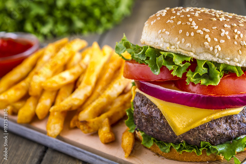 Hamburger on sesame seed bun with fries
