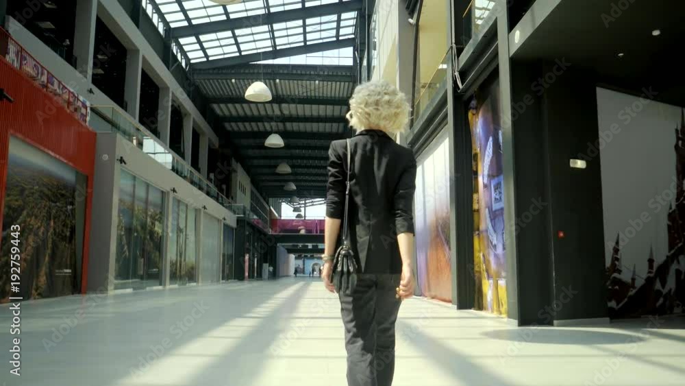 custom made wallpaper toronto digitalShot from behind of a stunning blonde model walking in the shopping mall alone. Beautiful design of a building.
