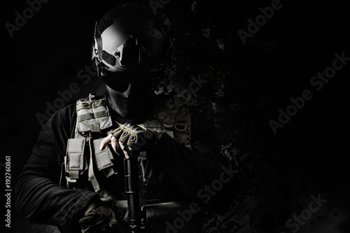 Εκτύπωση καμβά Black and white swat soldier posing with dissolving effect on black background