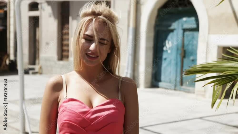 young blonde woman pink short red dress pose photographer outdoor street city sunshine sunny day charming smile soft backlight professional hairstyle makeup pretty cutegirl fashion caucasian young blonde woman pink short red dress pose photographer outdoor street city sunshine sunny day charming smile soft backlight professional hairstyle makeup pretty cutegirl fashion caucasian