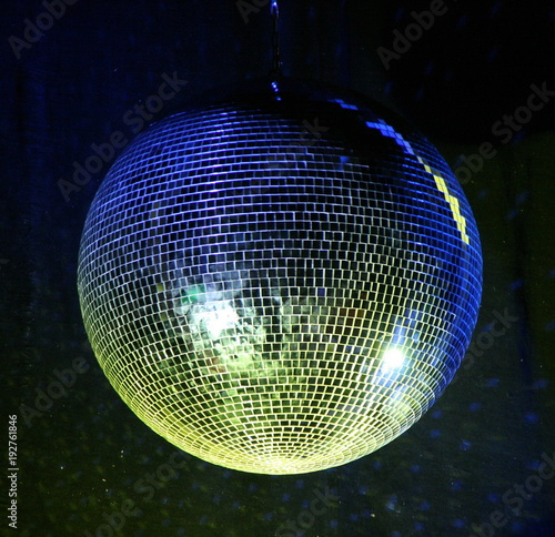 night club lighting yellow mirror-ball over black
