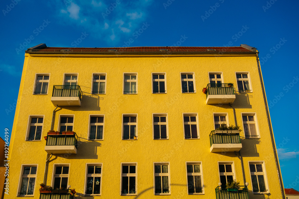 yellow colored apartment building in high contrasts