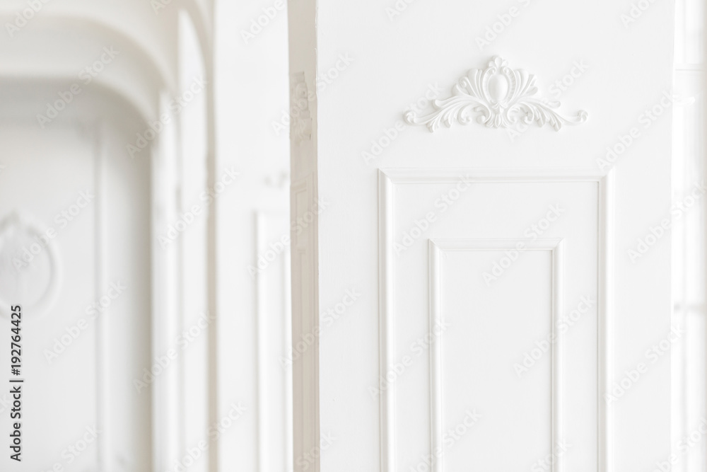 Expensive luxury interior. Stucco elements on light column. White patterned. Mouldings element from gypsum. Roccoco style Expensive luxury interior. Stucco elements on light column. White patterned. Mouldings element from gypsum. Roccoco style