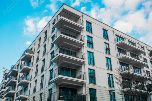 white and modern apartment complex with clean facade