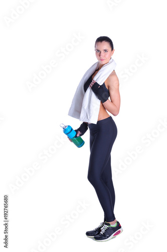 Young beautiful sport woman standing with a towel isolated on white background.
